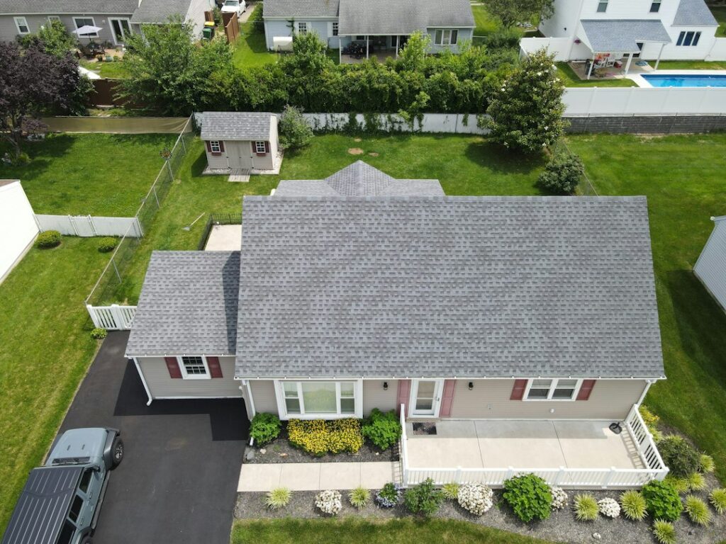 A freshly installed shingle roof on a well-maintained home with clean gutters and visible attic ventilation.