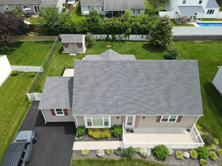 A freshly installed shingle roof on a well-maintained home with clean gutters and visible attic ventilation.